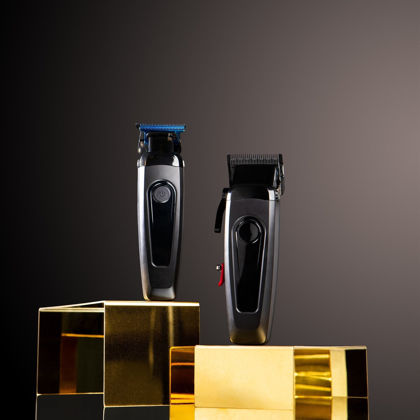 Two hair trimmers on gold blocks against a dark background