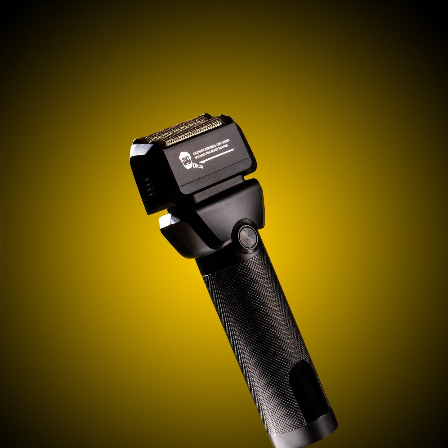 Black electric shaver on a yellow background