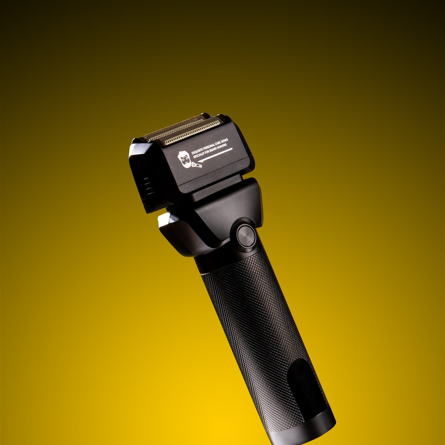 Black electric shaver on a yellow background