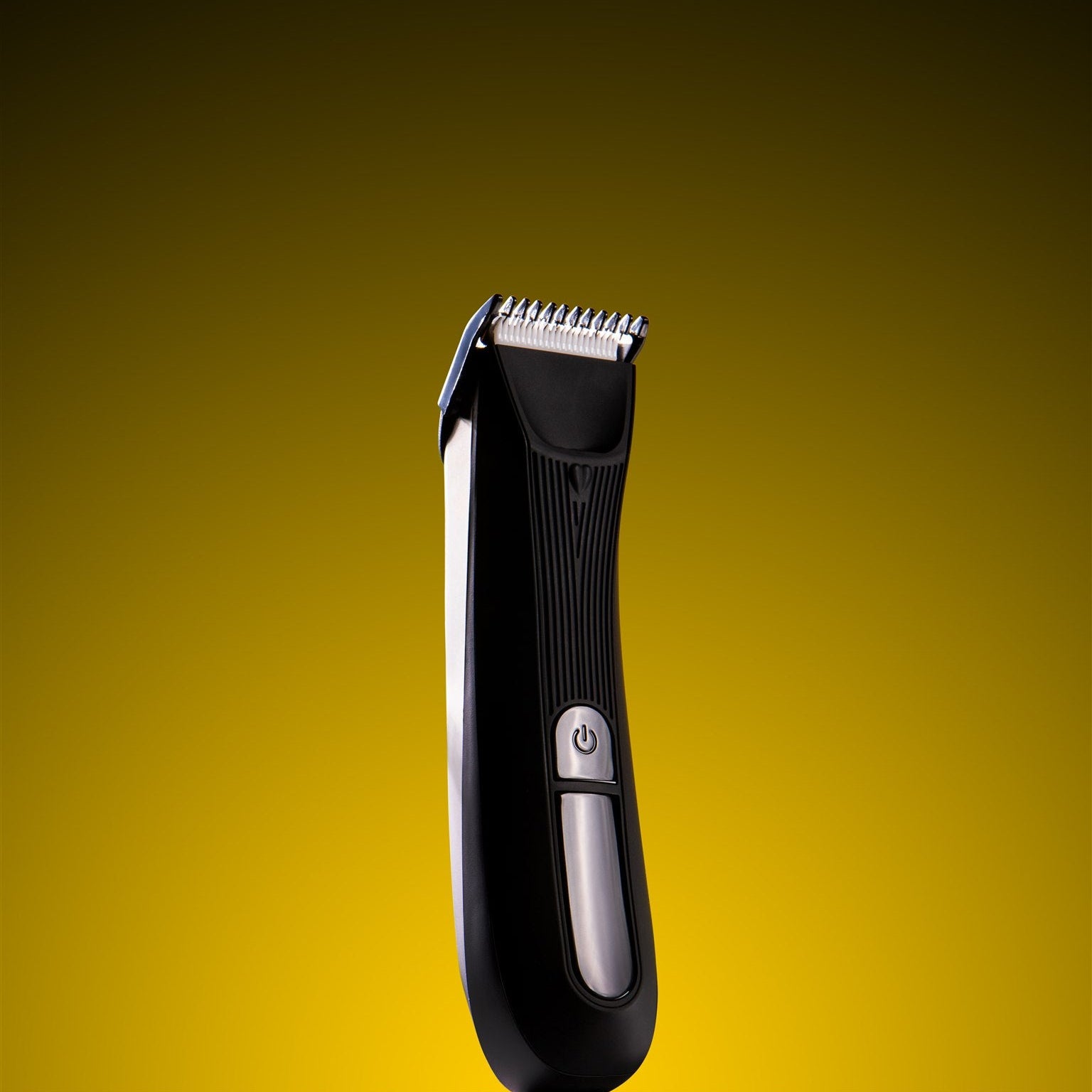 Black hair trimmer on a yellow background