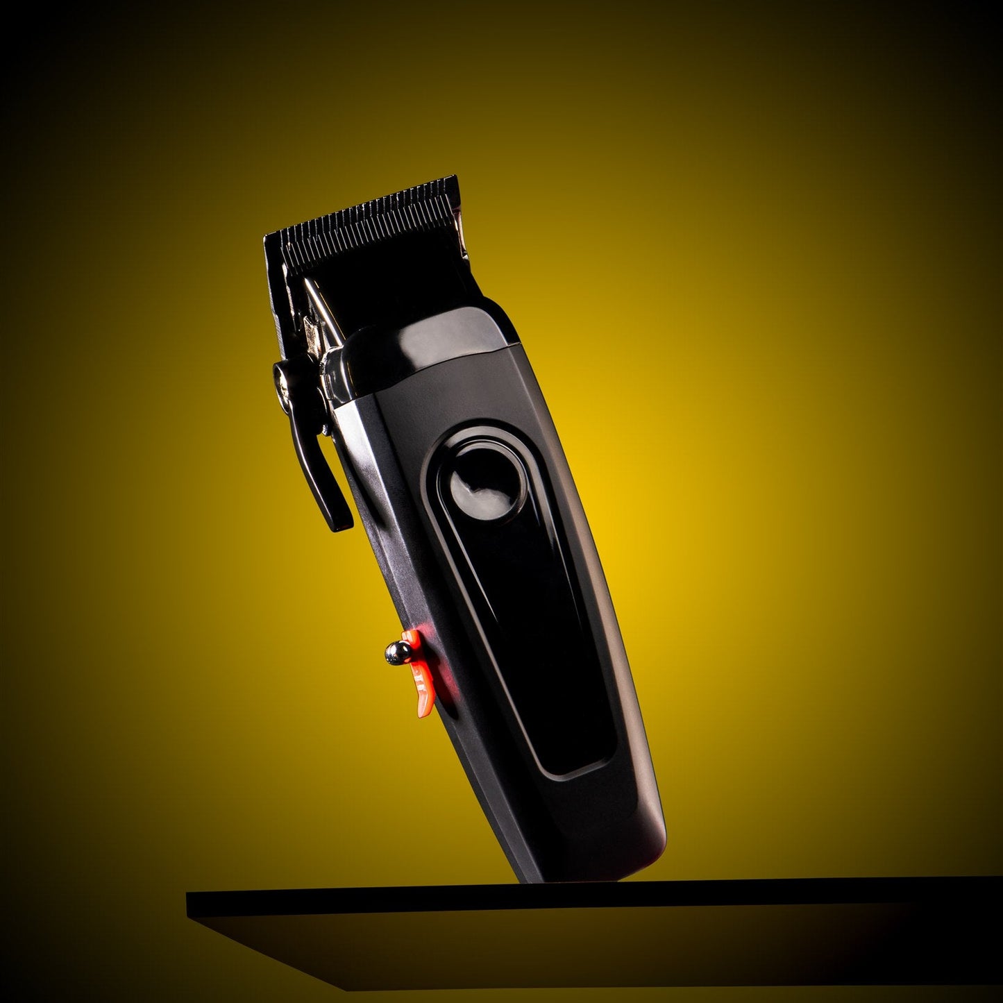 Black hair clipper on a yellow background