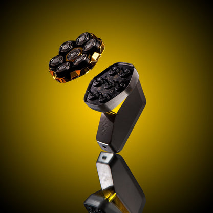 Black and gold grooming tool on a reflective surface with a yellow gradient background